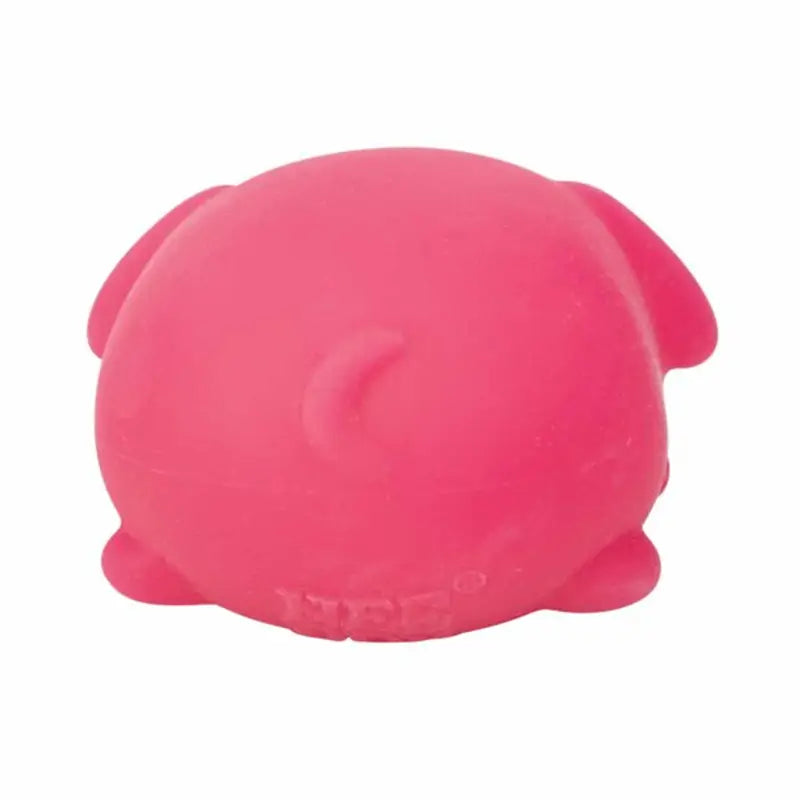 a soft bright pink plush sensory fidget toy shaped like a round squishy dog with small ears and feet viewed from the front showcasing its quick rebound feature