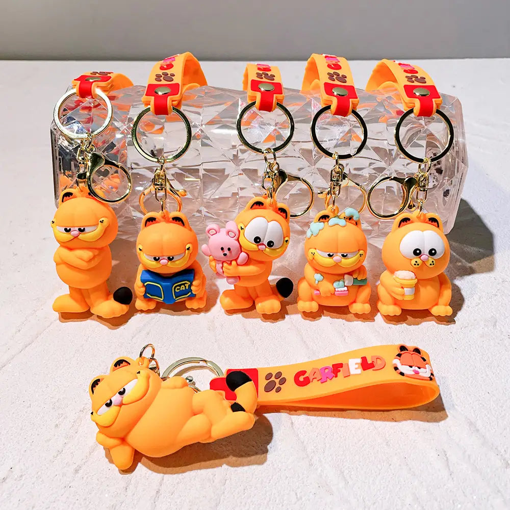 Orange Garfield keychain rubber anime cat key pendants featuring various poses and accessories, each attached to a metal ring and silicone wrist strap.