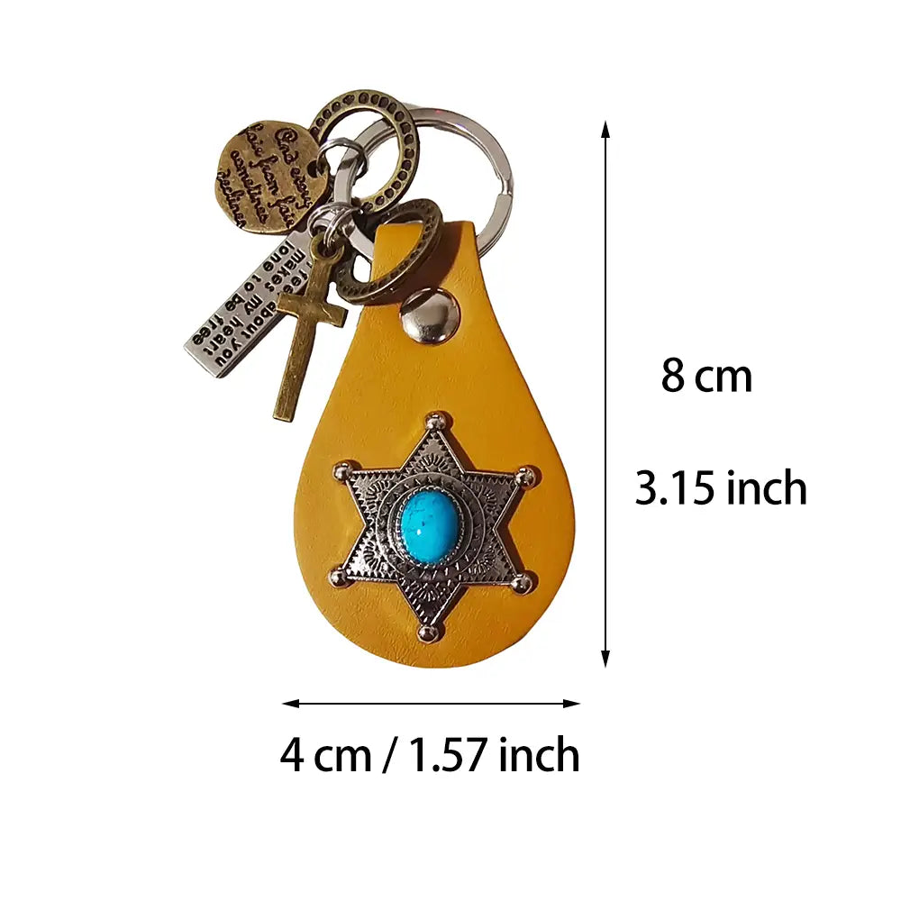 A yellow leather keychain featuring a silver star-shaped badge with a turquoise stone center adorned with cross and engraved metal tag charms for a leather turquoise star keychain charm gift.