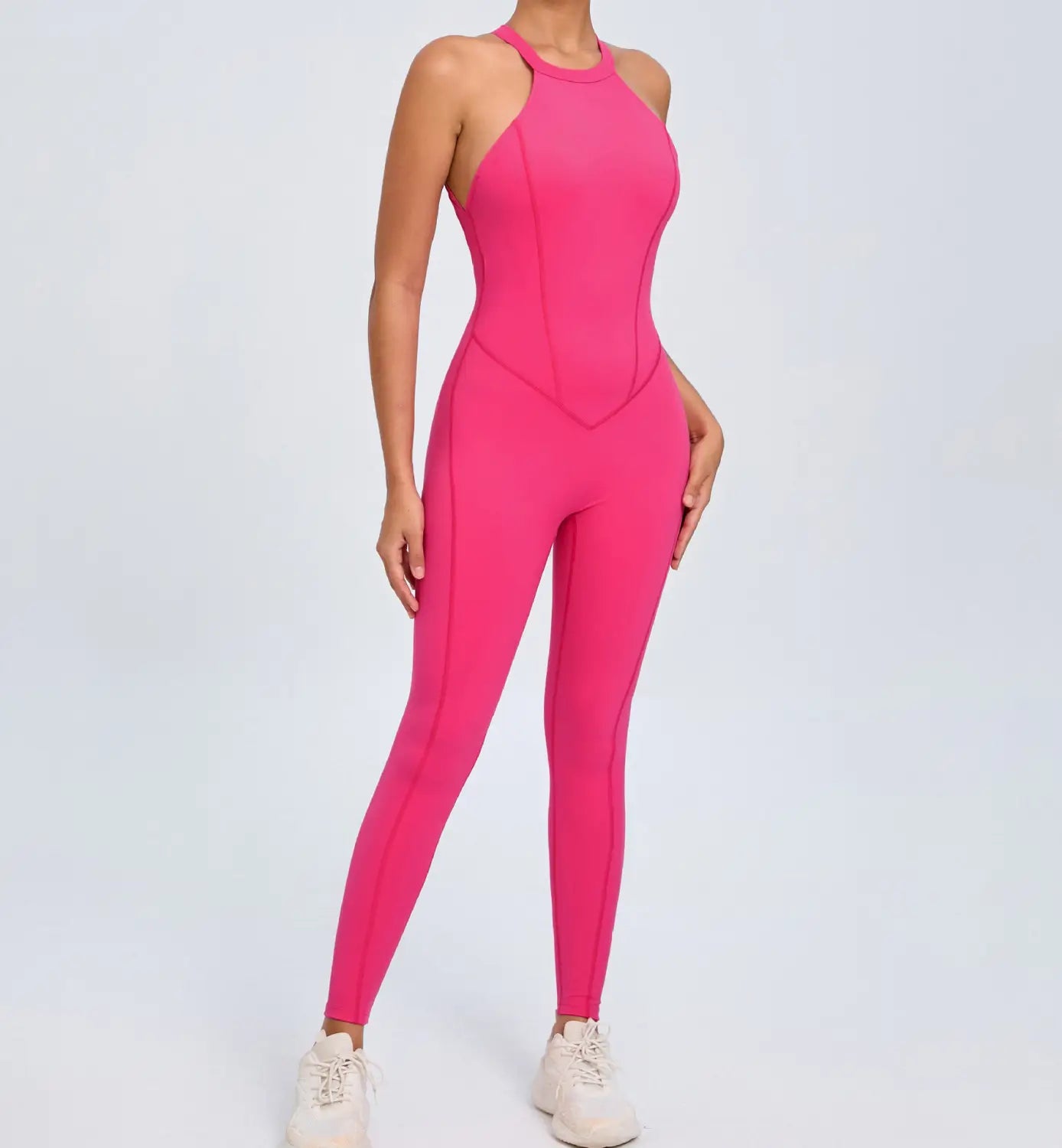 A vibrant pink form-fitting athletic jumpsuit with a high neckline and sleek seams shown from the back featuring an open back design ideal for workouts.
