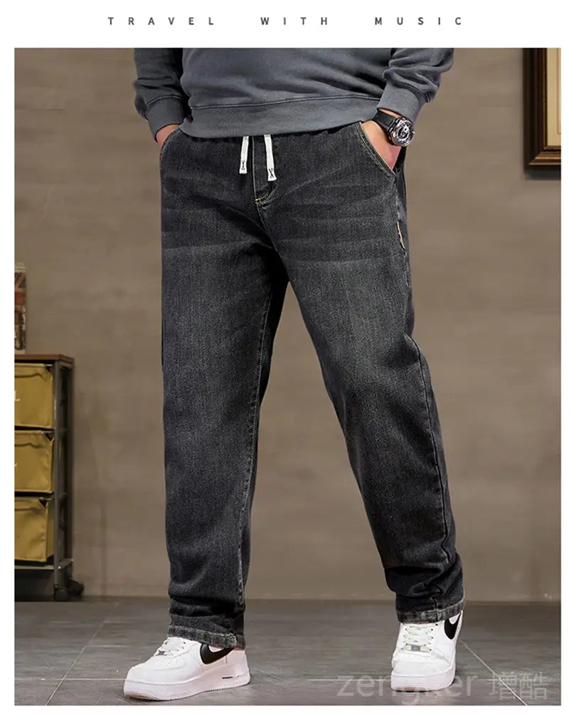 plus size elastic waist loose straight dark-wash denim jeans with white drawstrings at the waistband.