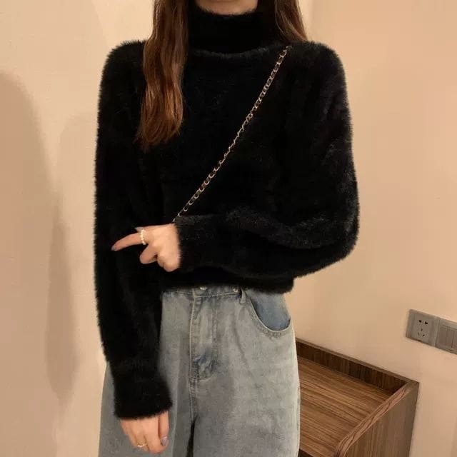 black fuzzy turtleneck sweater for women with long sleeves made of warm knit material ideal for winter wear.