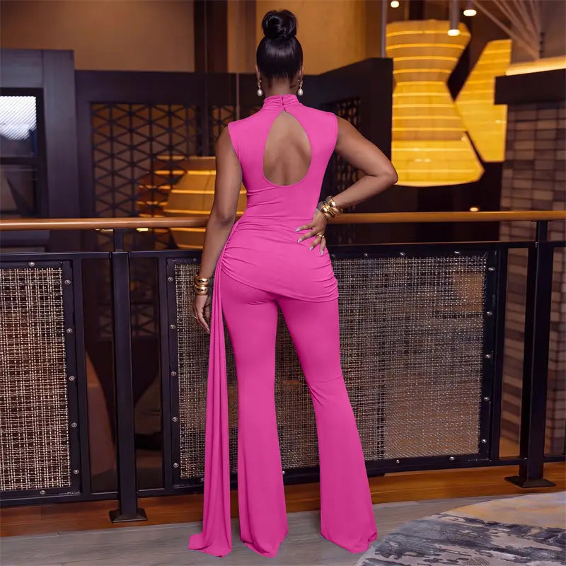 A vibrant fuchsia sleeveless piece sets woman jumpsuit featuring ruched fabric, a high neckline, open back closure type, and flared legs.