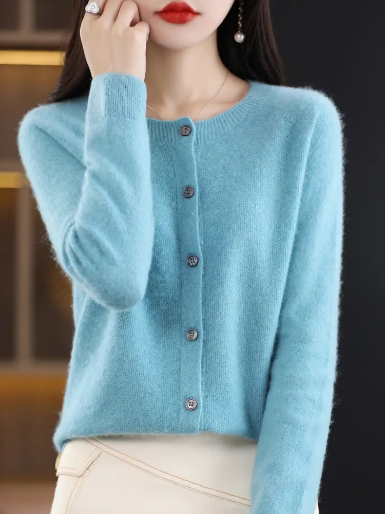 A soft light blue merino wool cardigan for women featuring a round neckline and five dark buttons down the front.