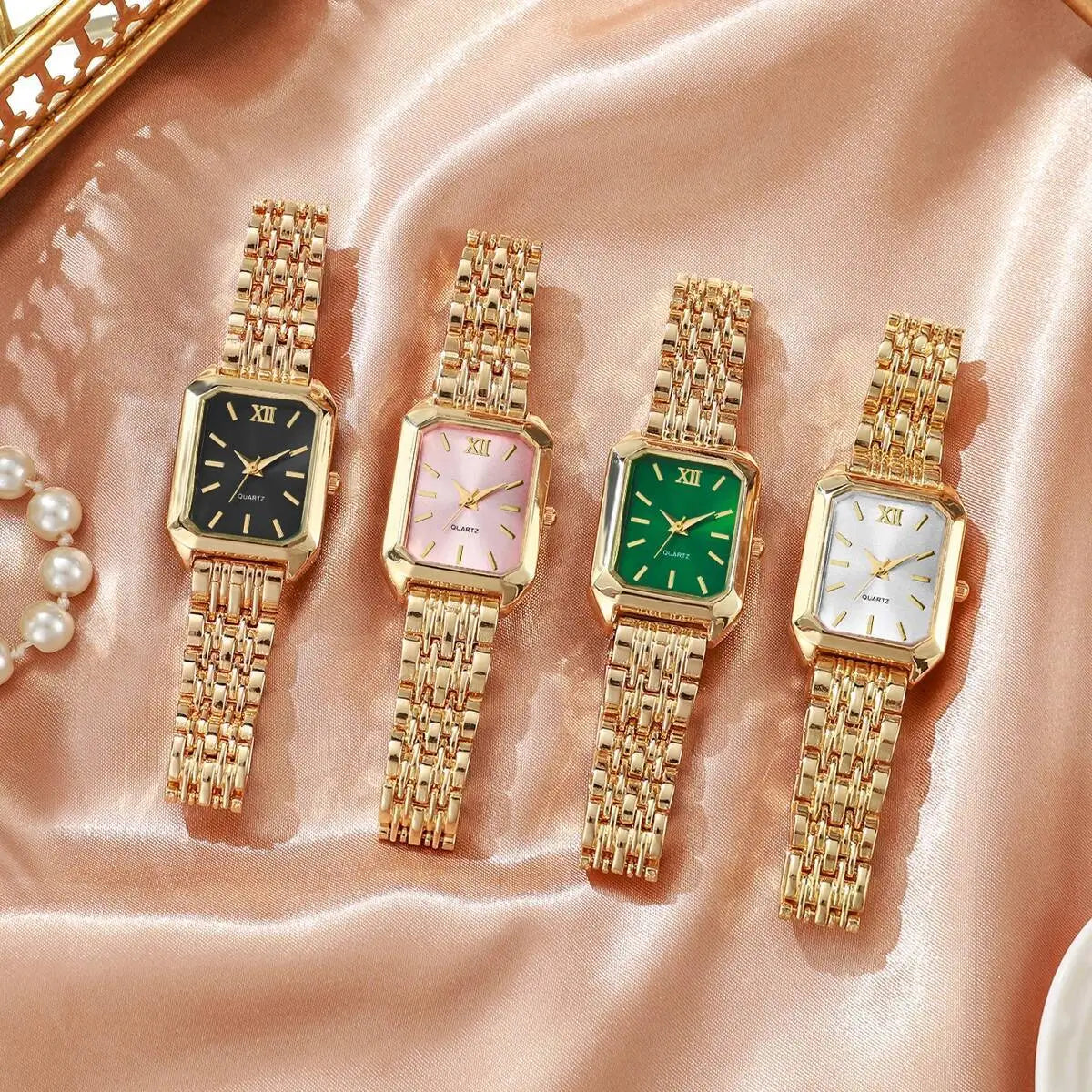 Four elegant women gold rectangle quartz watches with mesh straps and roman numeral dials in black pink green and white colors.
