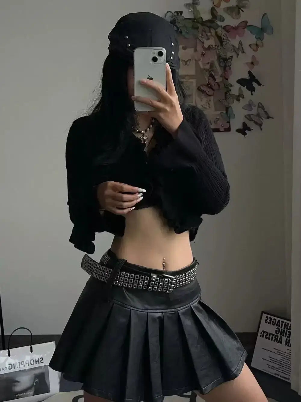 Black pleated leather mini skirt featuring a studded leather punk belt for edgy fashion style.