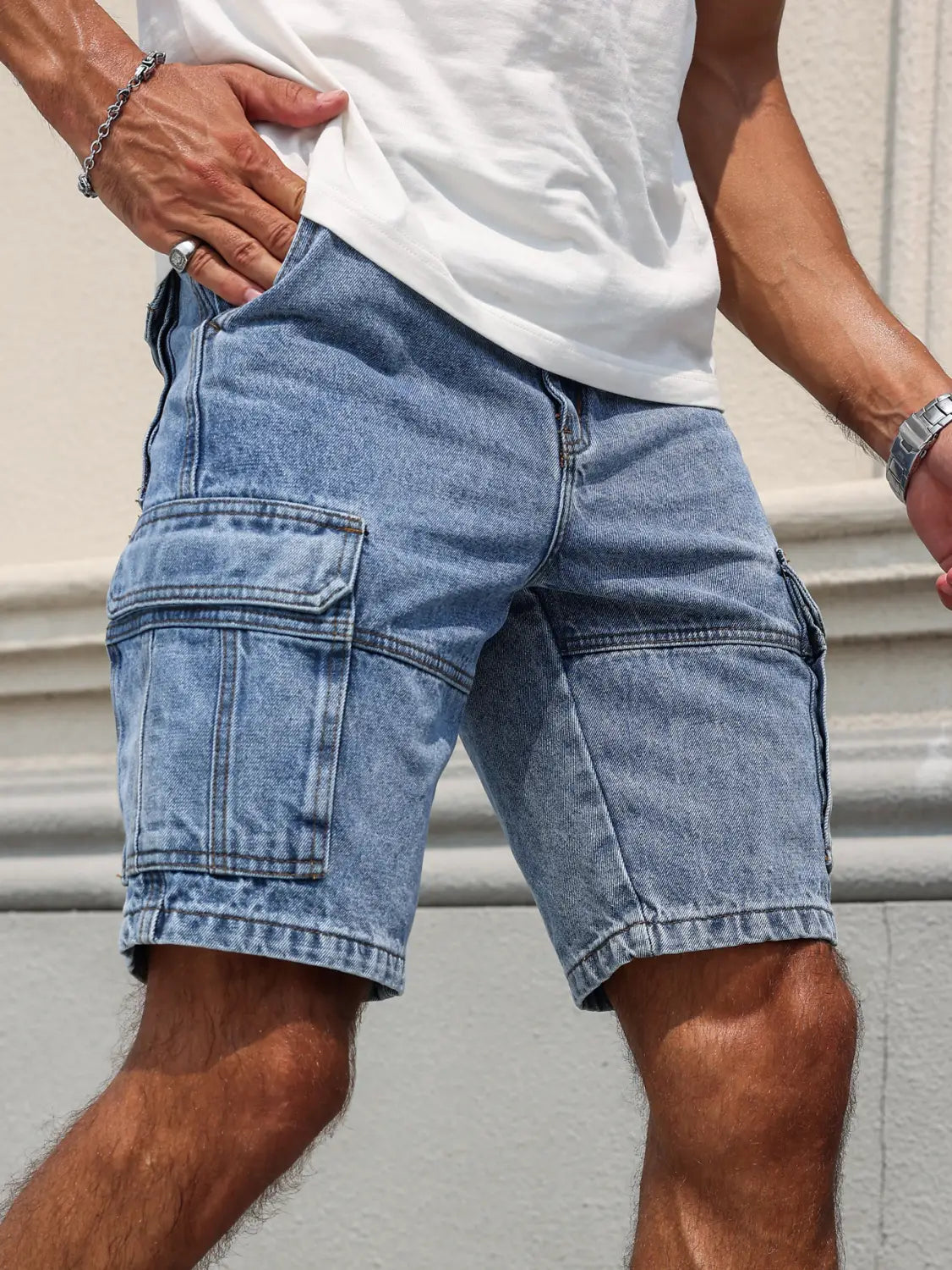 Men blue denim cargo shorts in light wash with multiple pockets and a regular relaxed fit for casual wear.