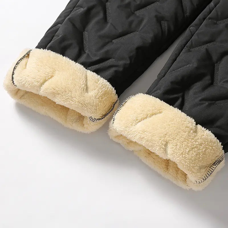 men fleece lined thermal sweatpants in black quilted fabric with plush cream colored fleece lining designed for waterproof winter wear