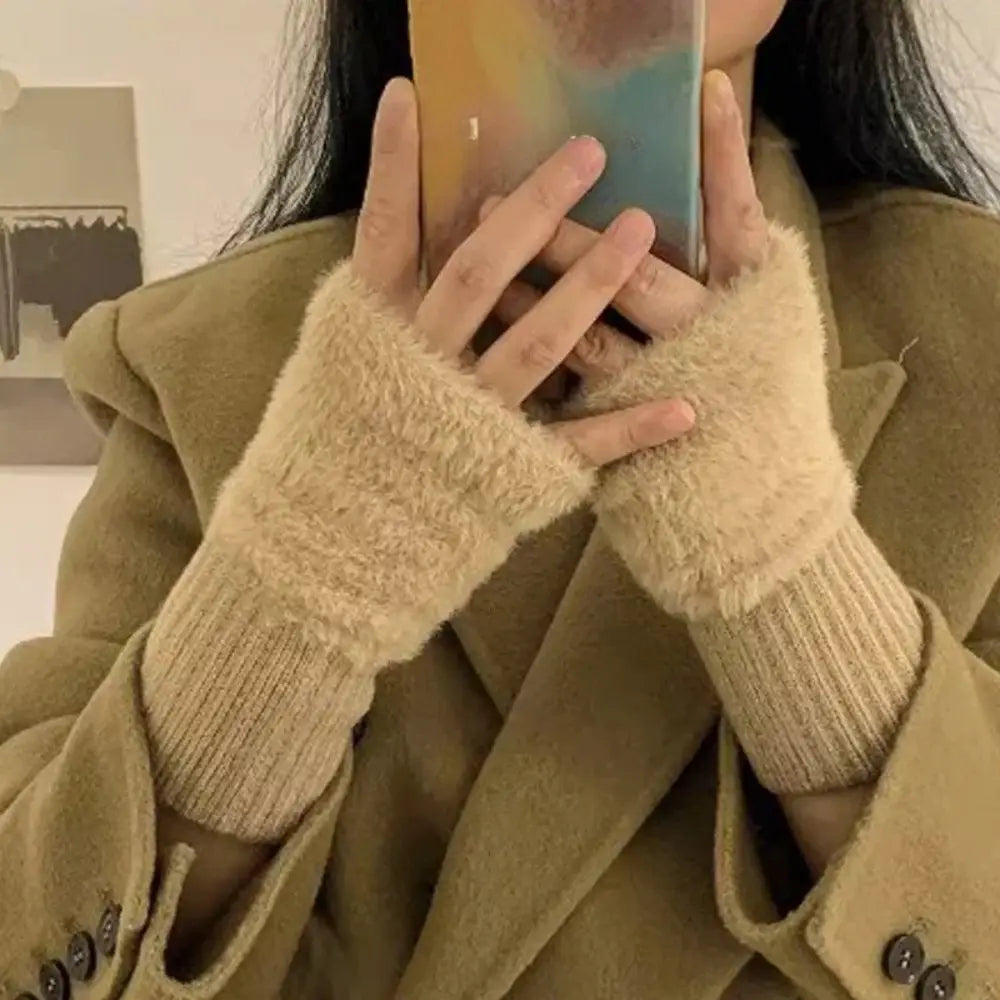 Beige fluffy fingerless knit gloves with fuzzy texture and ribbed cuffs shown from the back side.