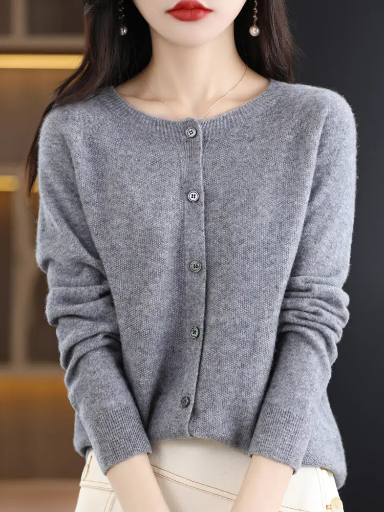 A soft heather gray merino wool cardigan for women featuring a round neckline and five matching buttons down the front.