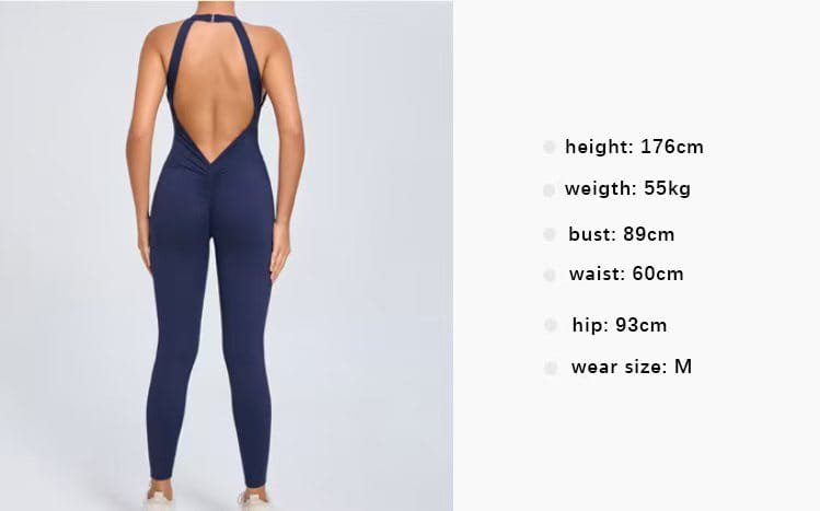 Navy blue halter neck one-piece workout jumpsuit with a deep back cutout shown from the back side.