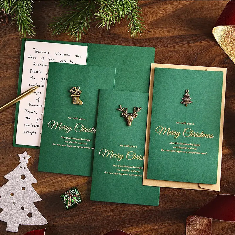 Set of three dark green Christmas greeting cards with metallic charms and elegant gold foil lettering included in a Christmas Greeting Cards Set with Gold Foil Envelopes.