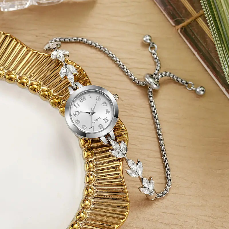silver-toned women rhinestone quartz watch with a delicate chain bracelet adorned with clear crystal leaf charms