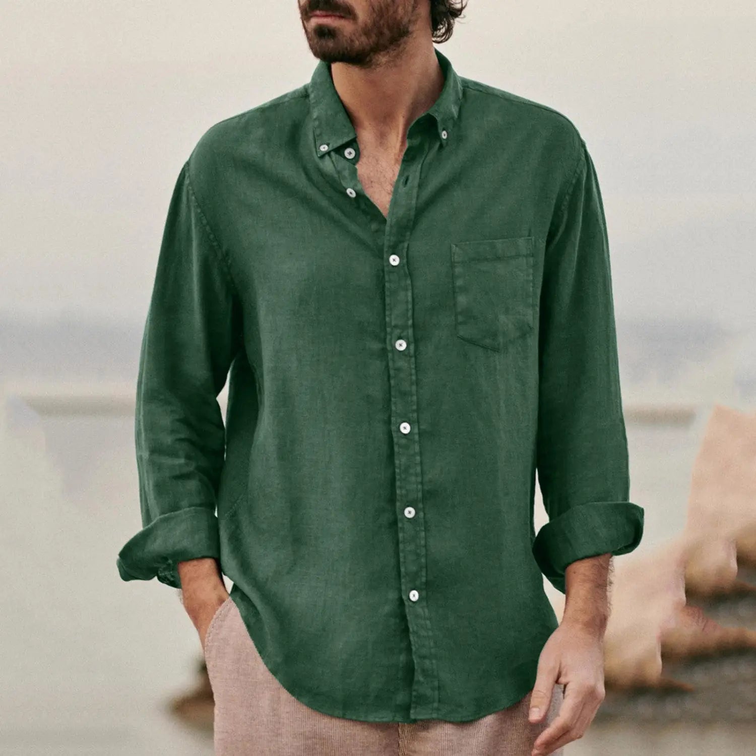 Dark green men linen blend casual shirt with white buttons and a chest pocket.