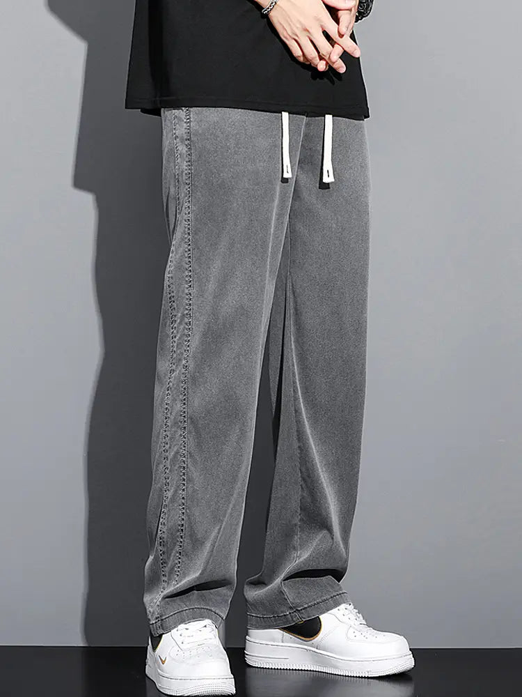 Men’s lyocell casual loose straight gray corduroy trousers with white drawstrings and a relaxed fit.
