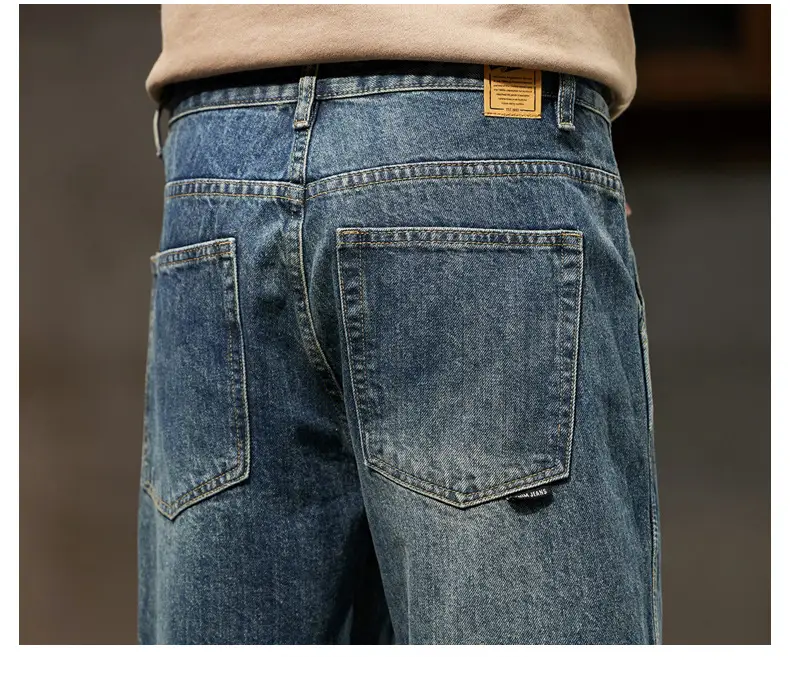 men loose denim harem jeans blue denim with a faded wash and classic back pockets shown from the back side