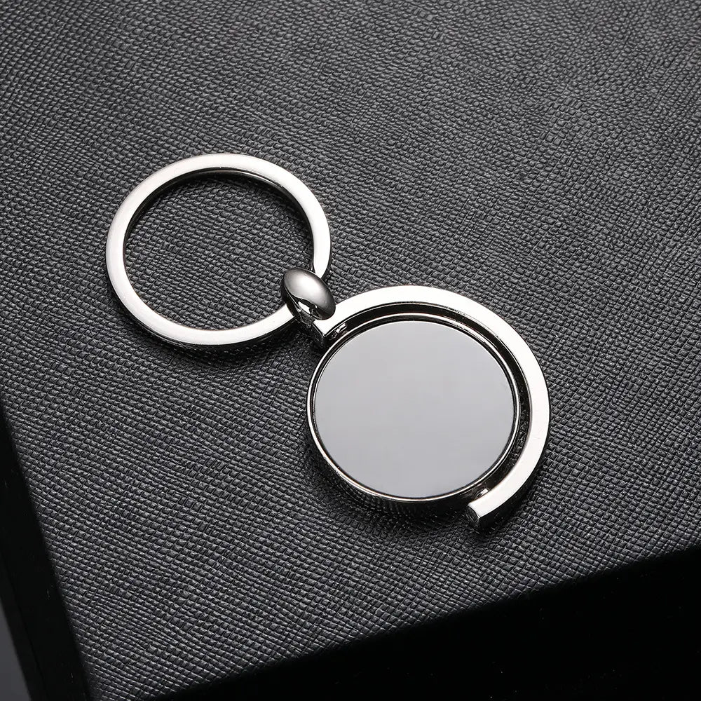Silver metallic rotating silver circle keychain gift featuring a circular rotating disc design.