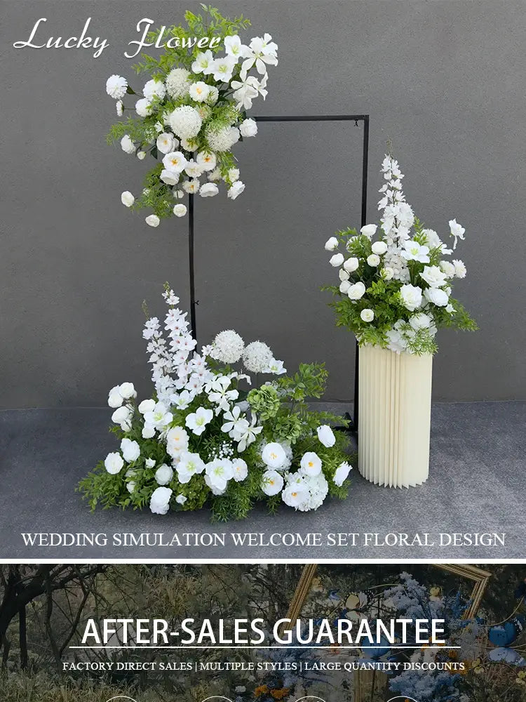 Elegant white artificial flowers wedding arch floral backdrop with lush greenery arranged in a tall cream-colored pleated vase suspended above a matching floor display.