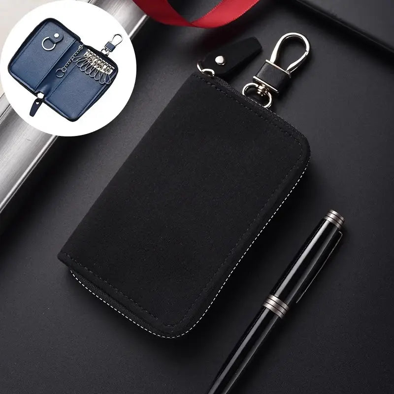 Black leather key holder organizer pouch with silver-toned metal clasp and zipper featuring sleek design and contrasting white stitching along the edges