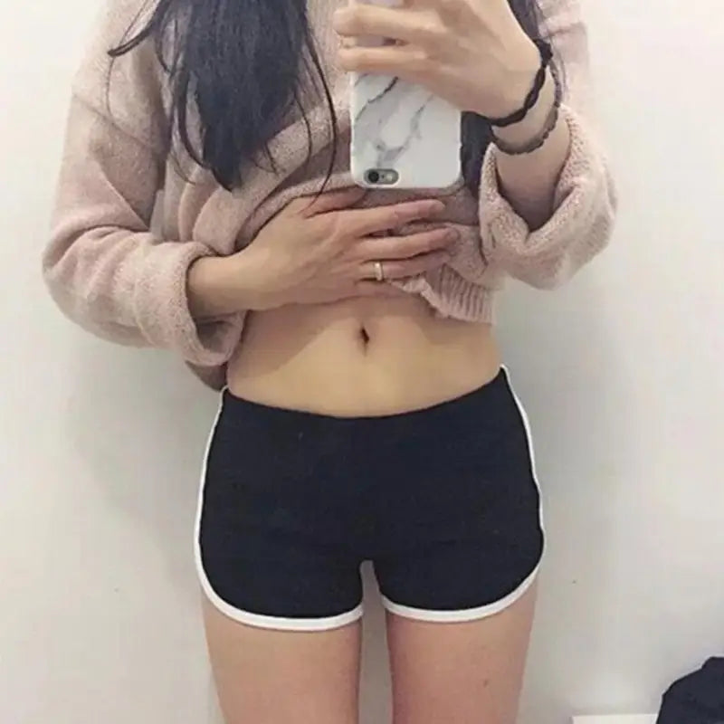 Black sports shorts women with elastic waist and white trim designed for casual athletic wear