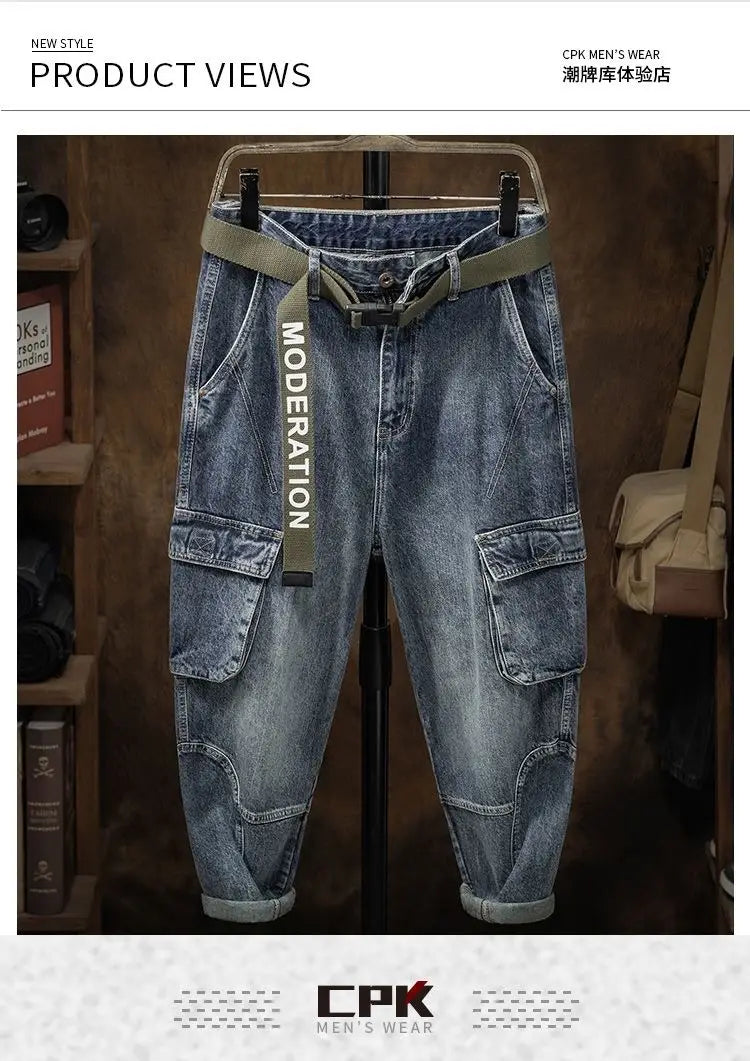 Men denim cargo jeans casual loose pants in blue denim with olive green belt featuring moderation text on the strap.