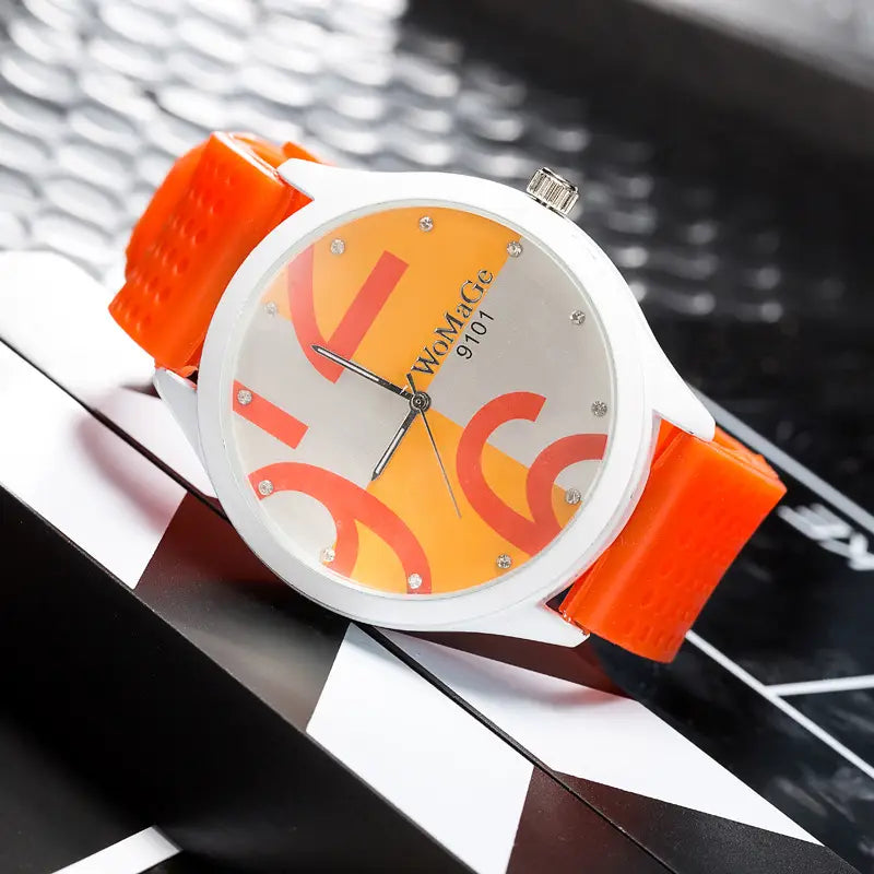 Womage silicone quartz women sports watch featuring an orange and white wristwatch with a bold abstract design on the face.