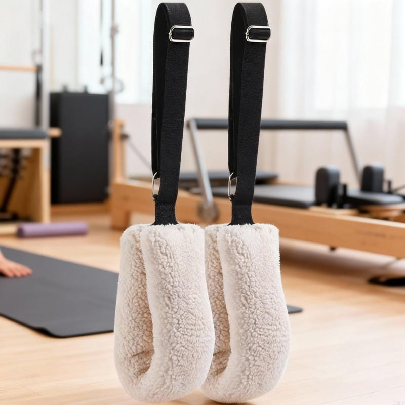 Cream-colored plush fleece hand grips with black adjustable pilates straps and stainless steel buckles for secure fit and comfort.