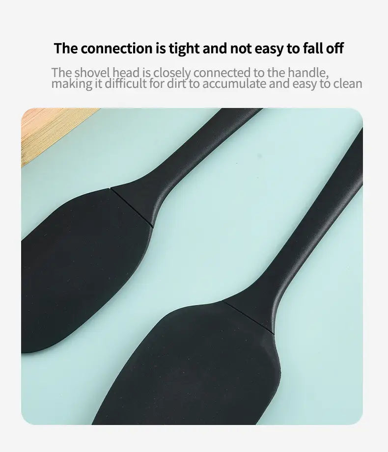 Black silicone spatula from kitchenware set with a smooth non-slip handle and slightly curved head for easy food scraping.