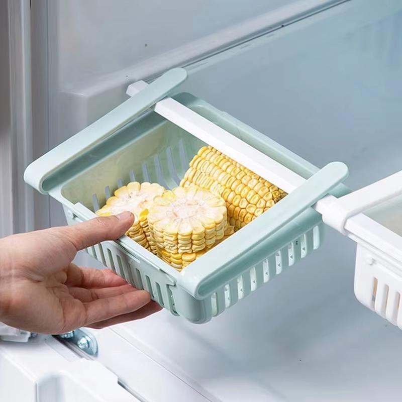 light blue plastic sink drain rack with slatted design and white interior made of food-grade polypropylene holding corn on the cob