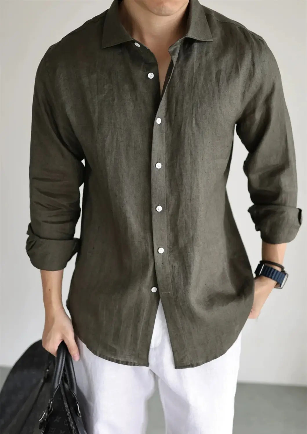 Men cotton linen casual button down shirt in olive green with rolled sleeves and white buttons.