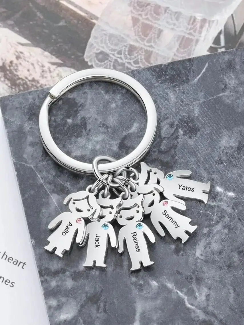 Silver family keychain personalized with custom engraved kids names and small gemstone accents.