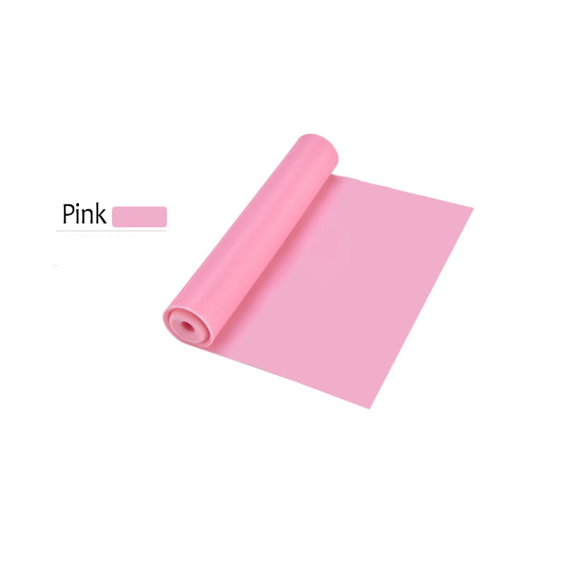 Pink silicone yoga mat rolled up and ready for use as part of resistance workout bands for home fitness