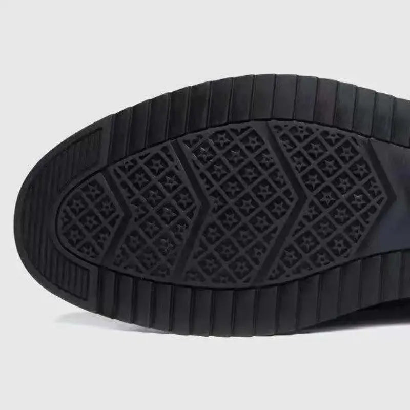 Black rubber sole with textured star and geometric line pattern on the back side of men casual leather sneakers lightweight non slip shoes.