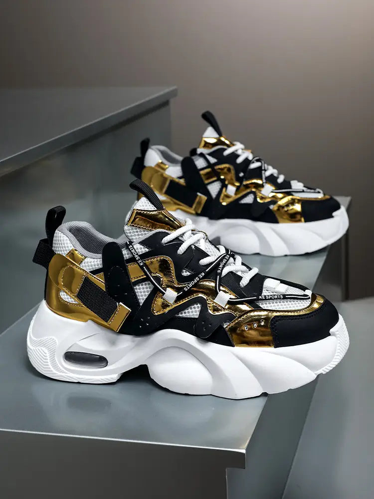 Men chunky air cushion casual sneakers in black and gold with white mesh accents featuring a bold metallic design and visible air cushioning in the sole.