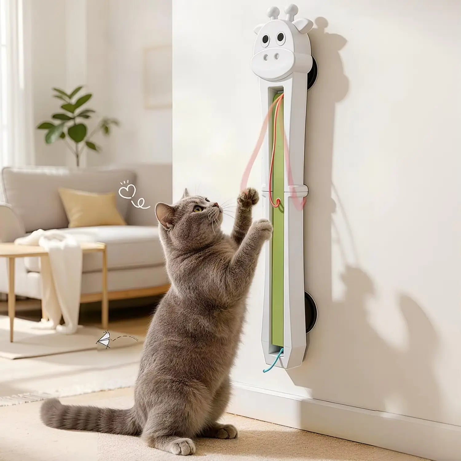 white giraffe-shaped automatic interactive cat toy wall mounted with green and pink dangling ribbons designed as an interactive cat toy for play and stimulation
