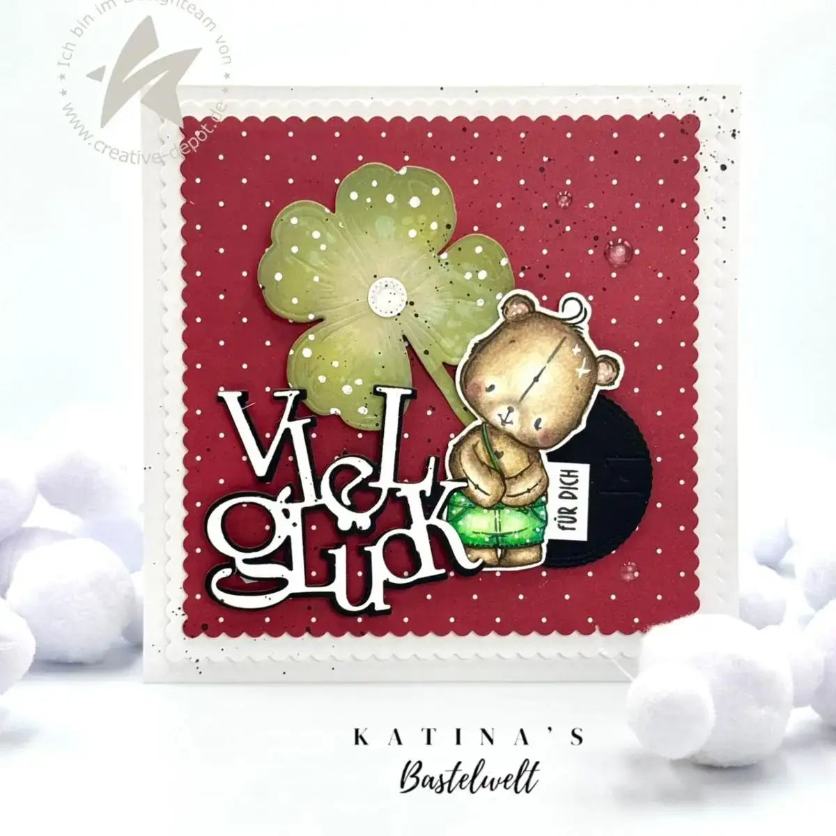 a charmingly illustrated handmade greeting card featuring a cute brown bear holding a green four-leaf clover on a red polka-dotted background with the phrase viel glück created using winter animal metal cutting dies for scrapbooking.
