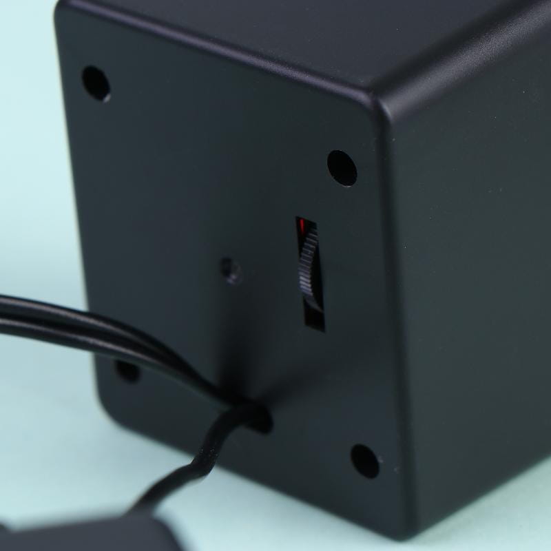 Black rectangular usb desktop speaker with small red indicator light and rotary dial on its side for stereo audio computer system.