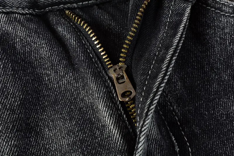 Men flare jeans distressed dark gray denim trousers featuring dark denim fabric with a metallic gold zipper and matching stitching.