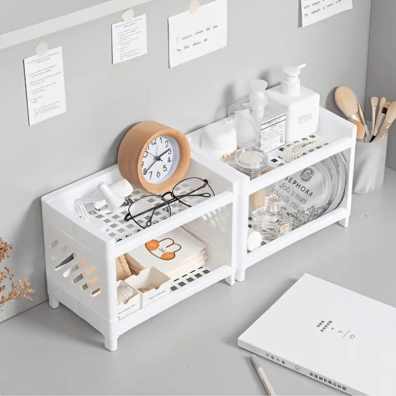 white plastic two-tiered storage rack with perforated sides and open compartments designed as a desk organizer
