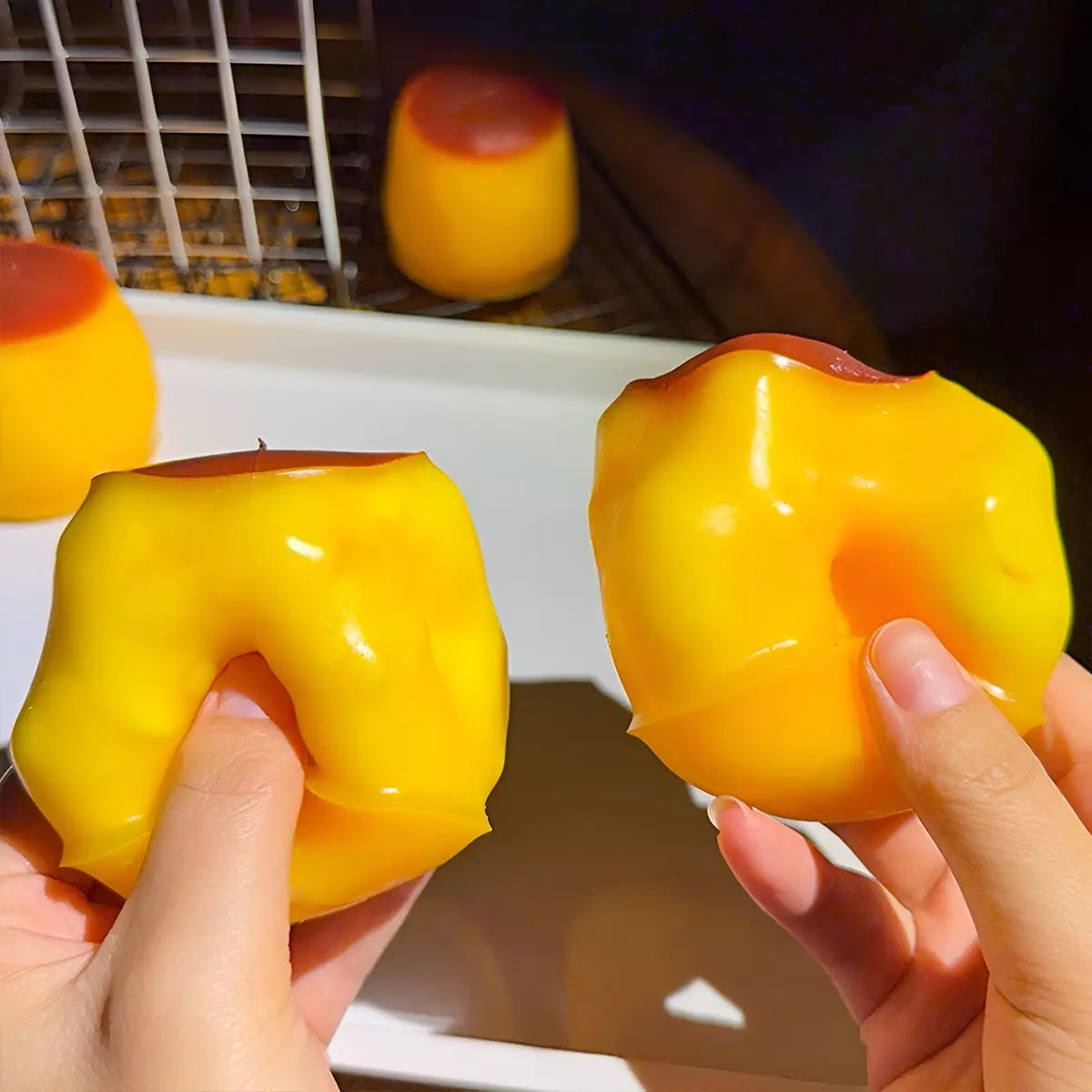 Pudding squishy asmr stress relief toy featuring a vibrant yellow glossy gelatin dessert with a smooth slightly translucent texture and a contrasting red center.