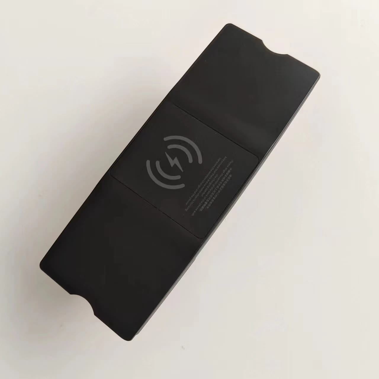 black rectangular wireless charging pad with a matte finish and subtle gray nfc symbol designed for audi a6 c7 rs6 s7 and rs7 models