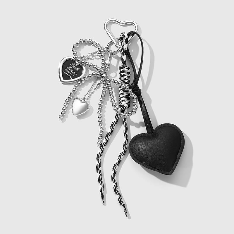 Silver heart-shaped bag keychain with black leather charm and beaded chains featuring a bowknot pendant.