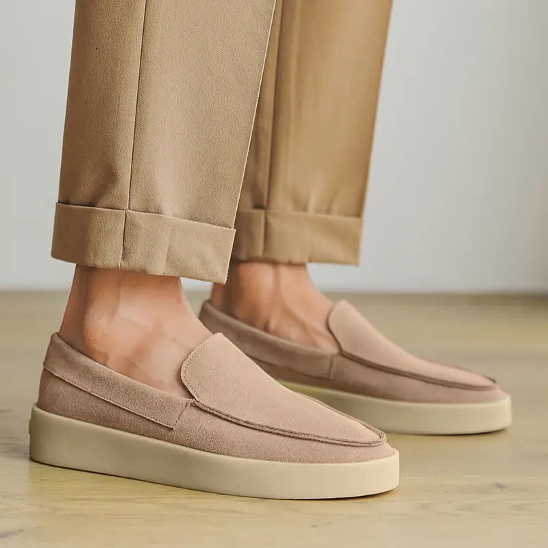 Beige suede men casual loafers with a clean minimalist design and white rubber soles for slip on walking shoes.