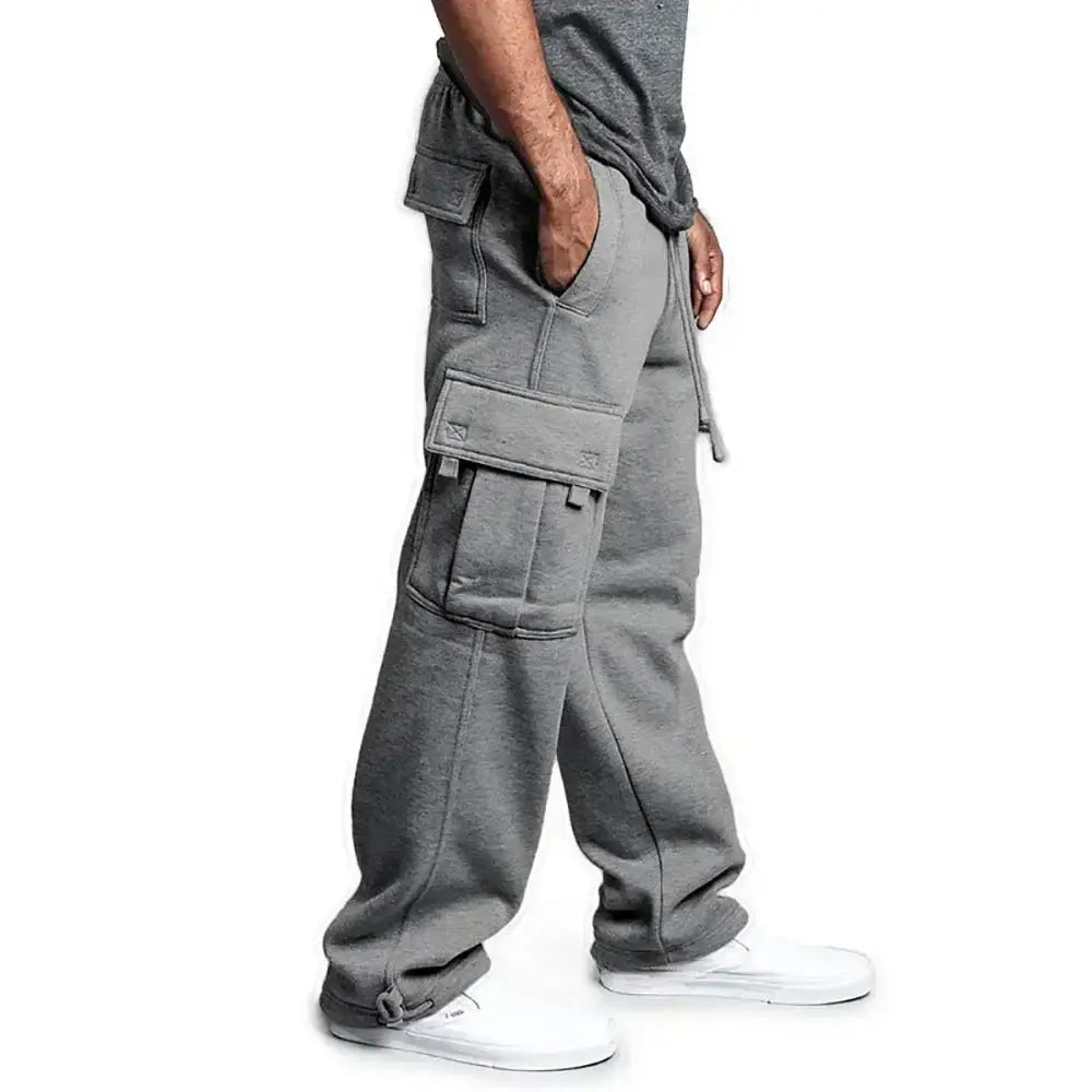 Pantalons cargo pour homme à coupe ample de style jogging, couleur grise, avec plusieurs poches et une taille à cordon de serrage conçue pour le confort et l'utilité.