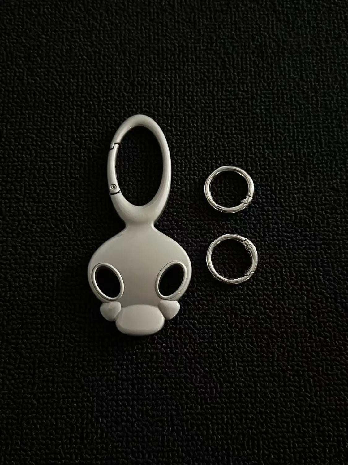 white enamel monkey-shaped skull metal car keychain bag charm with silver-toned metal clasp and two matching rings