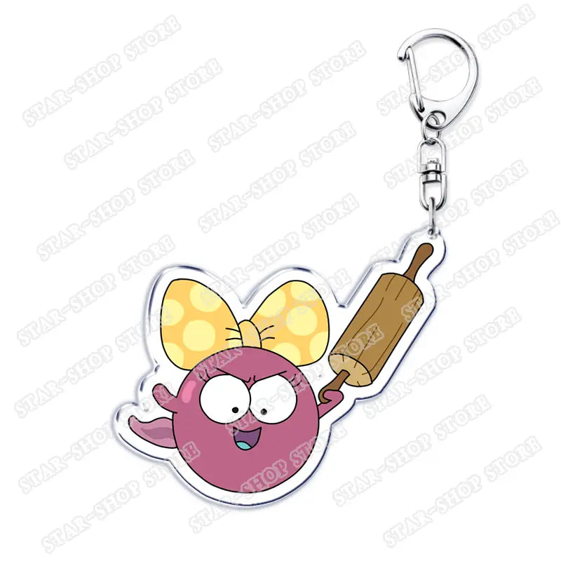 A pink round cartoon character with a yellow polka dot bow holding a wooden rolling pin featured on an acrylic Amphibia anime keychain.
