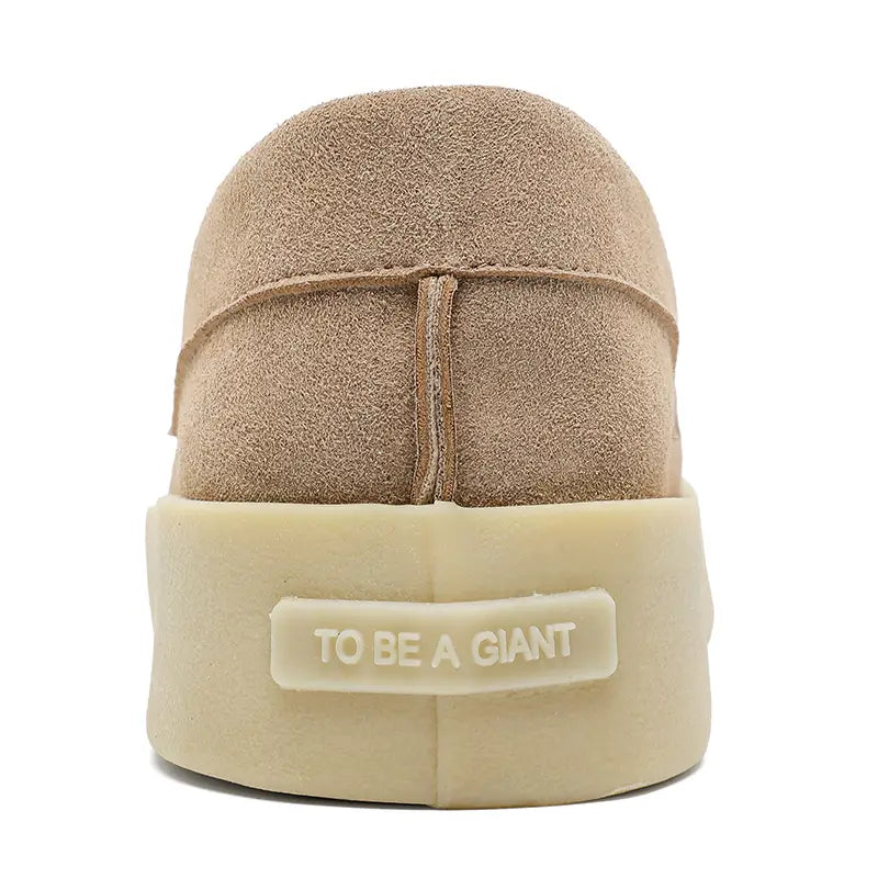 Beige suede slip-on men casual loafers with a thick off-white rubber sole embossed with to be a giant suitable for walking.