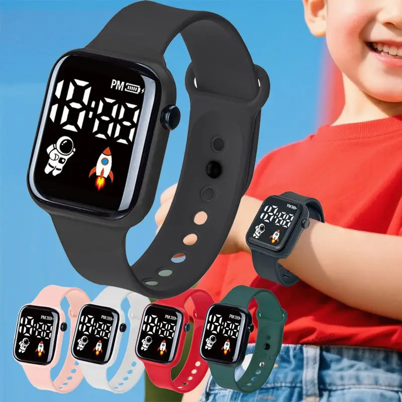 Montre électronique noire pour enfants avec icônes d’astronaute et de fusée sur l’affichage numérique LED, avec bracelet en silicone disponible en rose, blanc, rouge et vert pour garçons et filles.