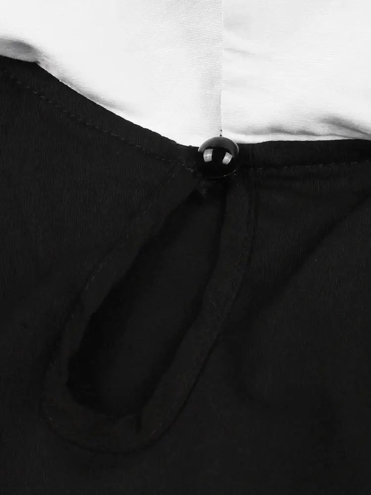 Black spherical button fastening the neckline of a tonval bat embroidery halloween vintage black dress