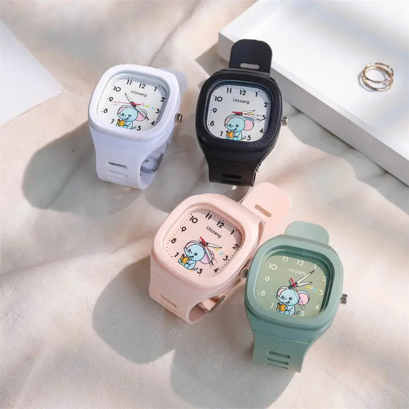 Four colorful kids luminous cartoon elephant digital watches with square faces, white dials, and silicone straps in white, black, pink, and mint green pastel shades.